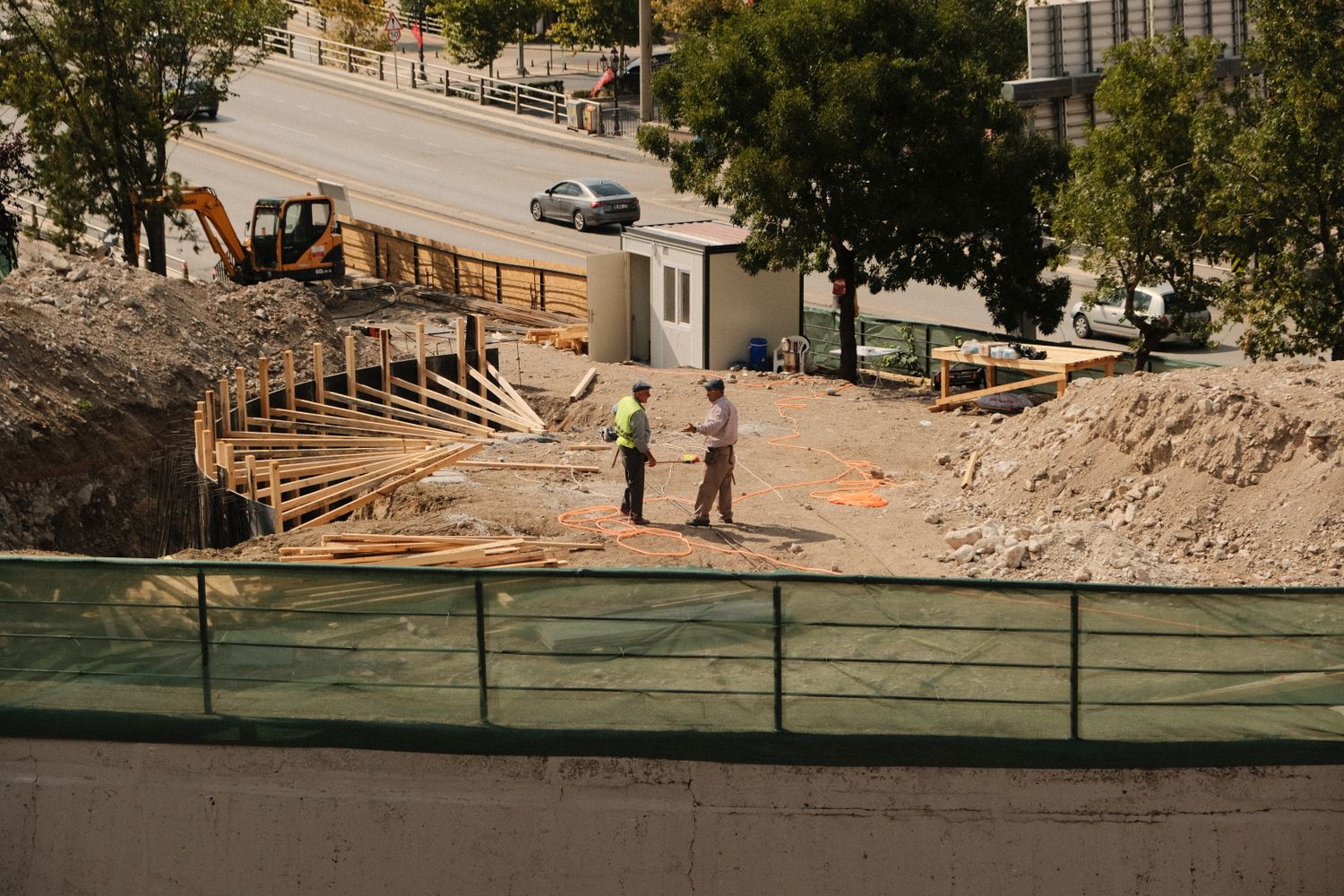 Two construction professionals discussing site conditions during excavation works